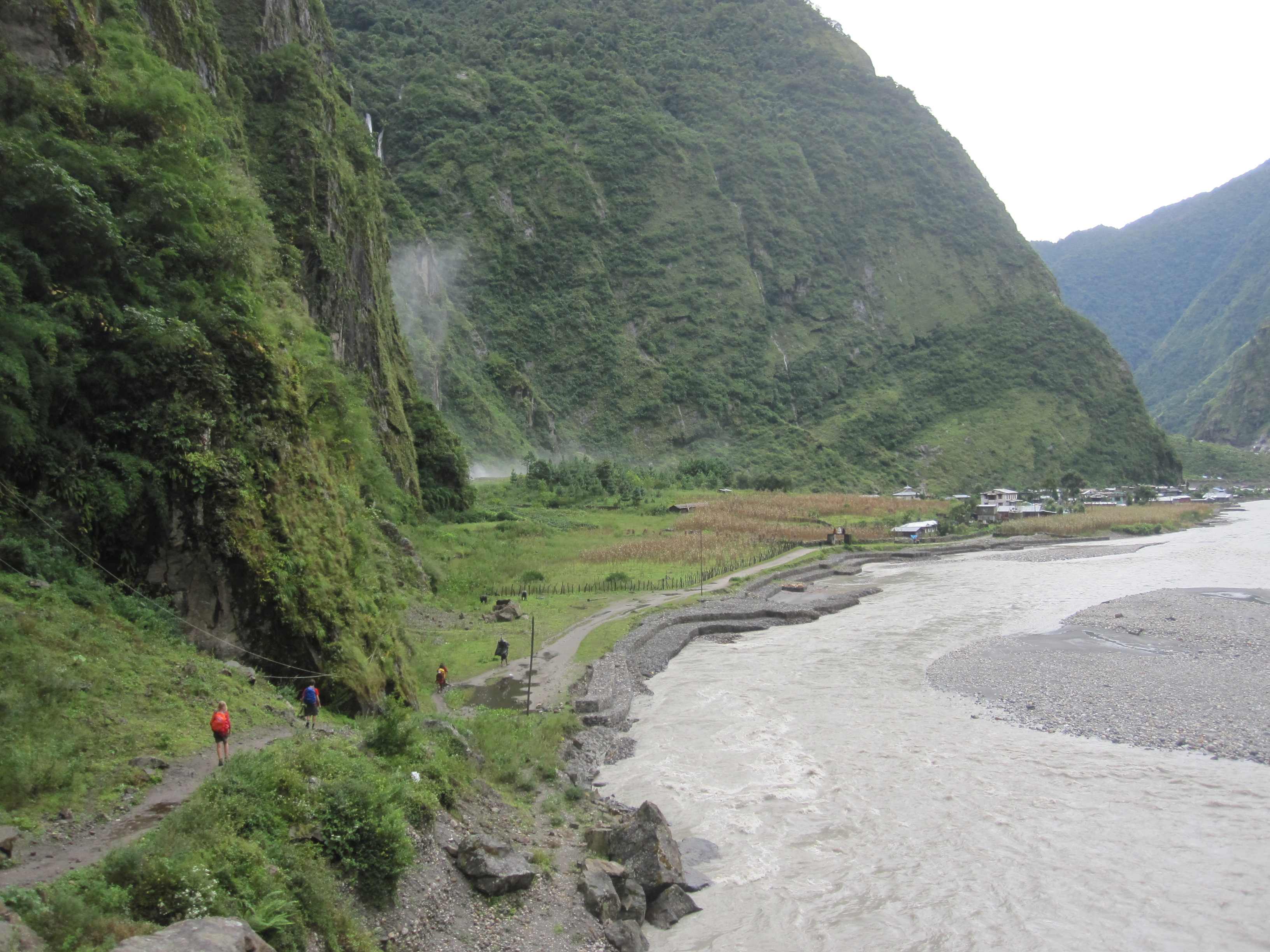 Marshyangdi River with mist of a powerful waterfall to the left